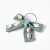 Hair bobble with bow and cowrie shells for girls, light green