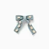 Hair slide with bow and cowrie shells for girls, light green