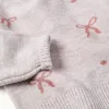 Knitted jumper with jacquard bows and dots for girls, light pink