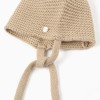 Knitted beanie with pompons and straps for newborns, beige/white