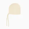 Cotton knitted cap with straps for newborns, light beige