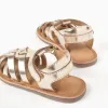 Leather fisherman sandals with crossed straps for baby girls, golden