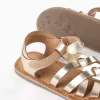 Leather fisherman sandals with crossed straps for baby girls, golden